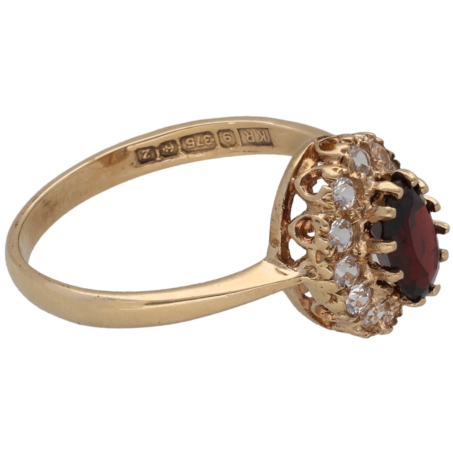 Gold-tone ring with engraved band and oval dark red gem in floral halo