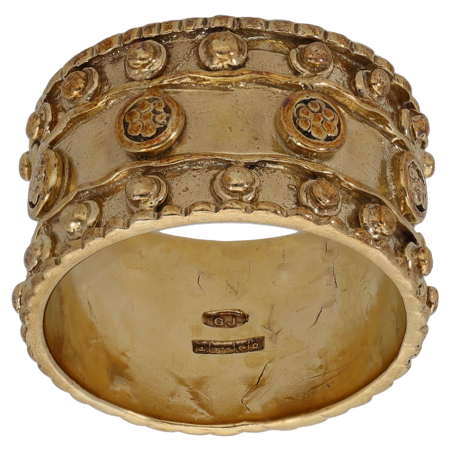 9ct gold wedding ring with raised patterned border and oval top, inner hallmark visible