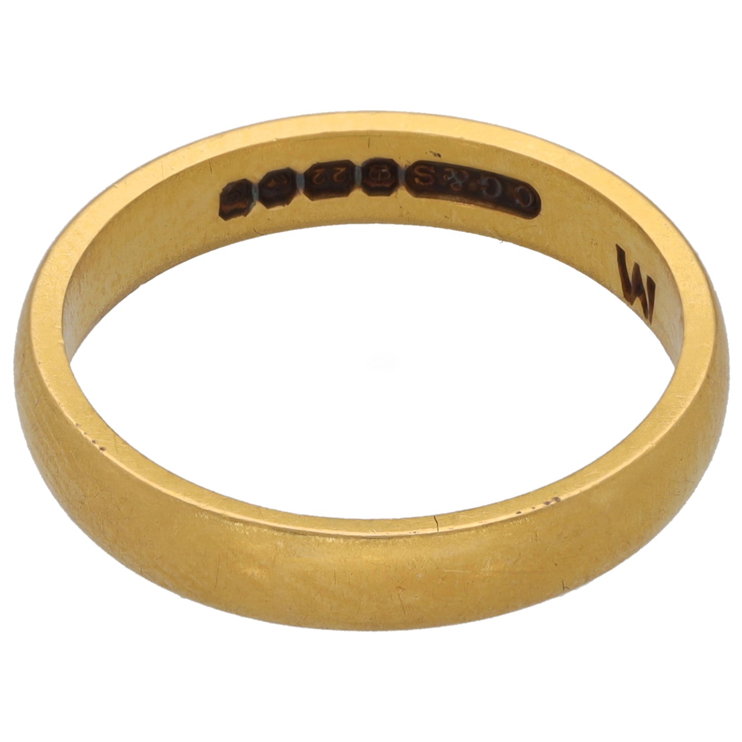 Plain gold wedding ring showing inner hallmark engraving and size marking