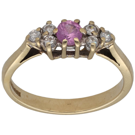 Gold dress ring with oval pink stone center and clear side accents