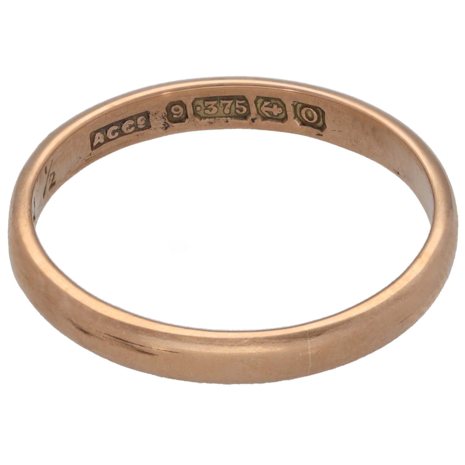 Plain rose gold wedding ring showing engraved outer hallmarks and maker marks