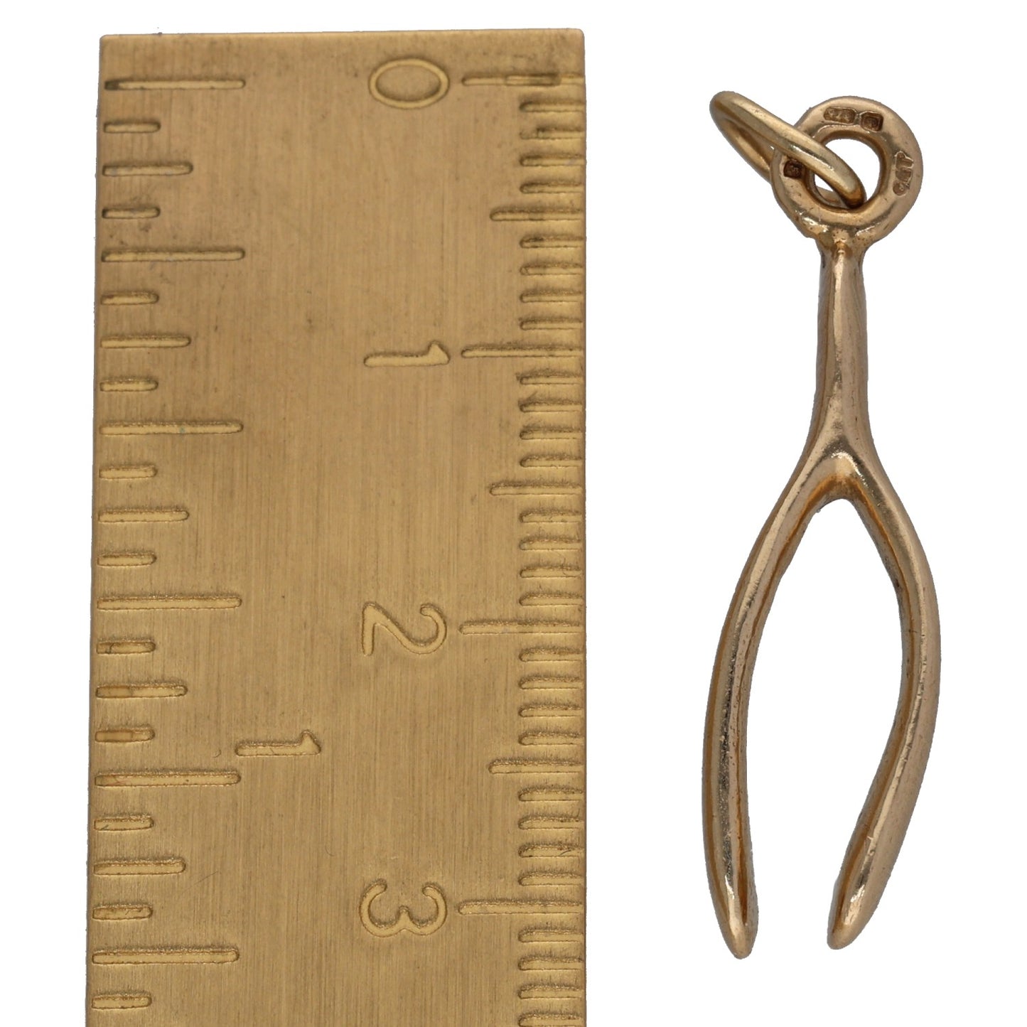 Openwork pendant with loop bail, gold-tone, shown next to ruler for scale
