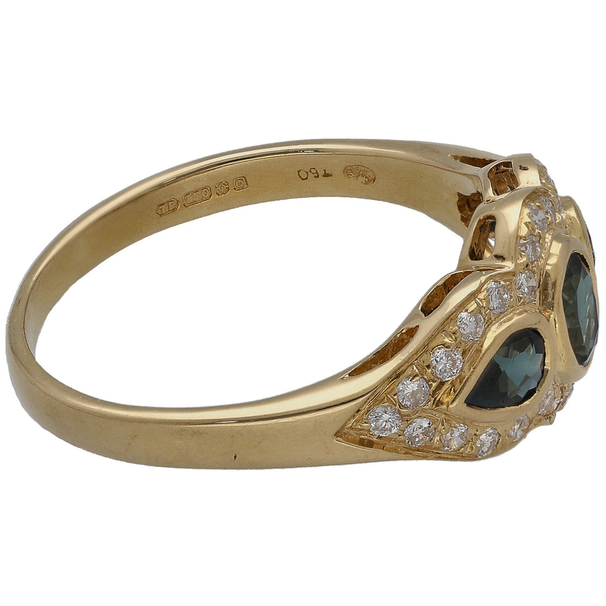 Gold ring with three round dark blue stones, diamond side halos, and inner band marks