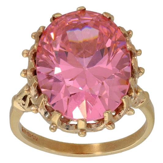 Gold-tone ring with large pink round CZ solitaire and decorative prong setting