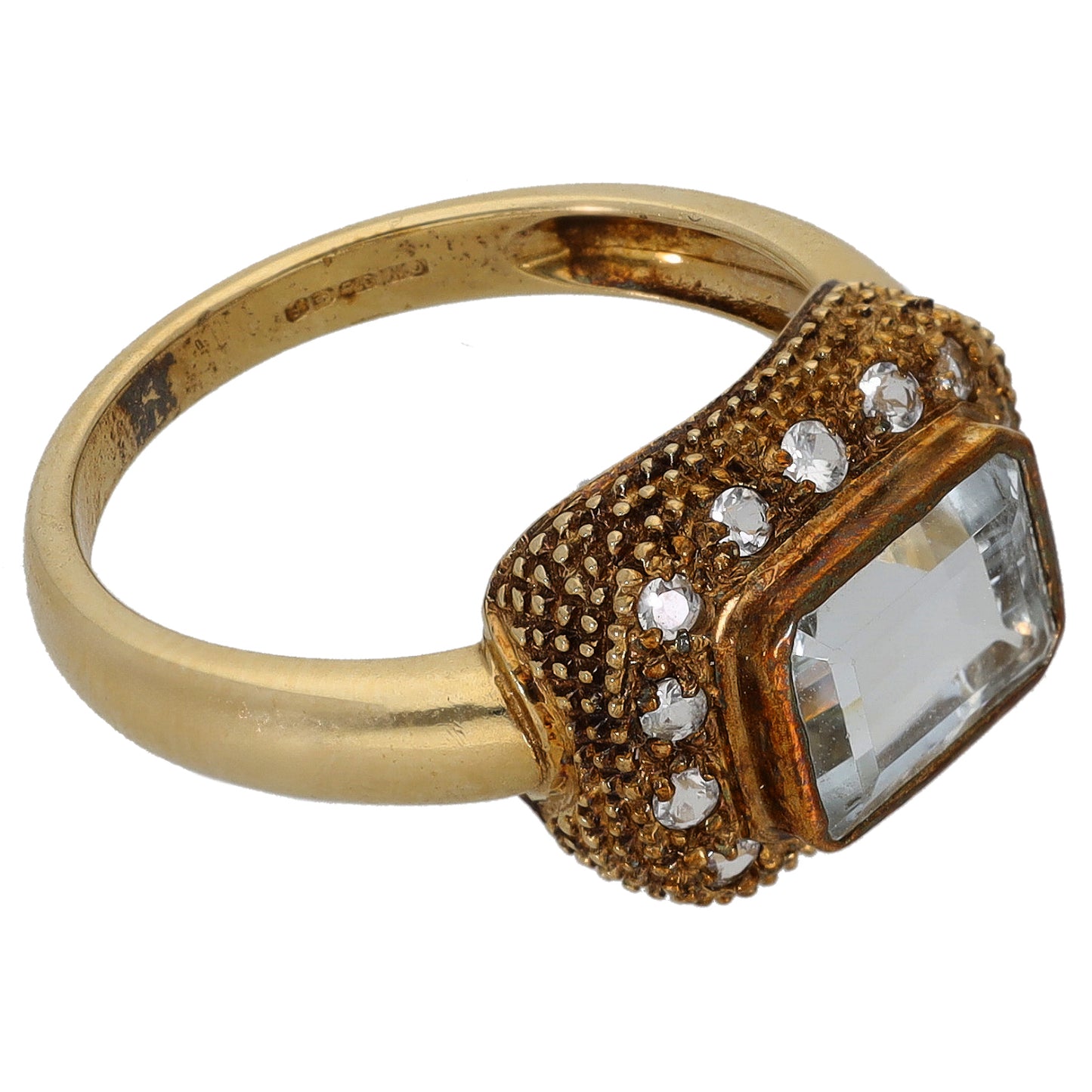 Gold cocktail ring with rectangular clear stone and rhinestone halo on textured setting