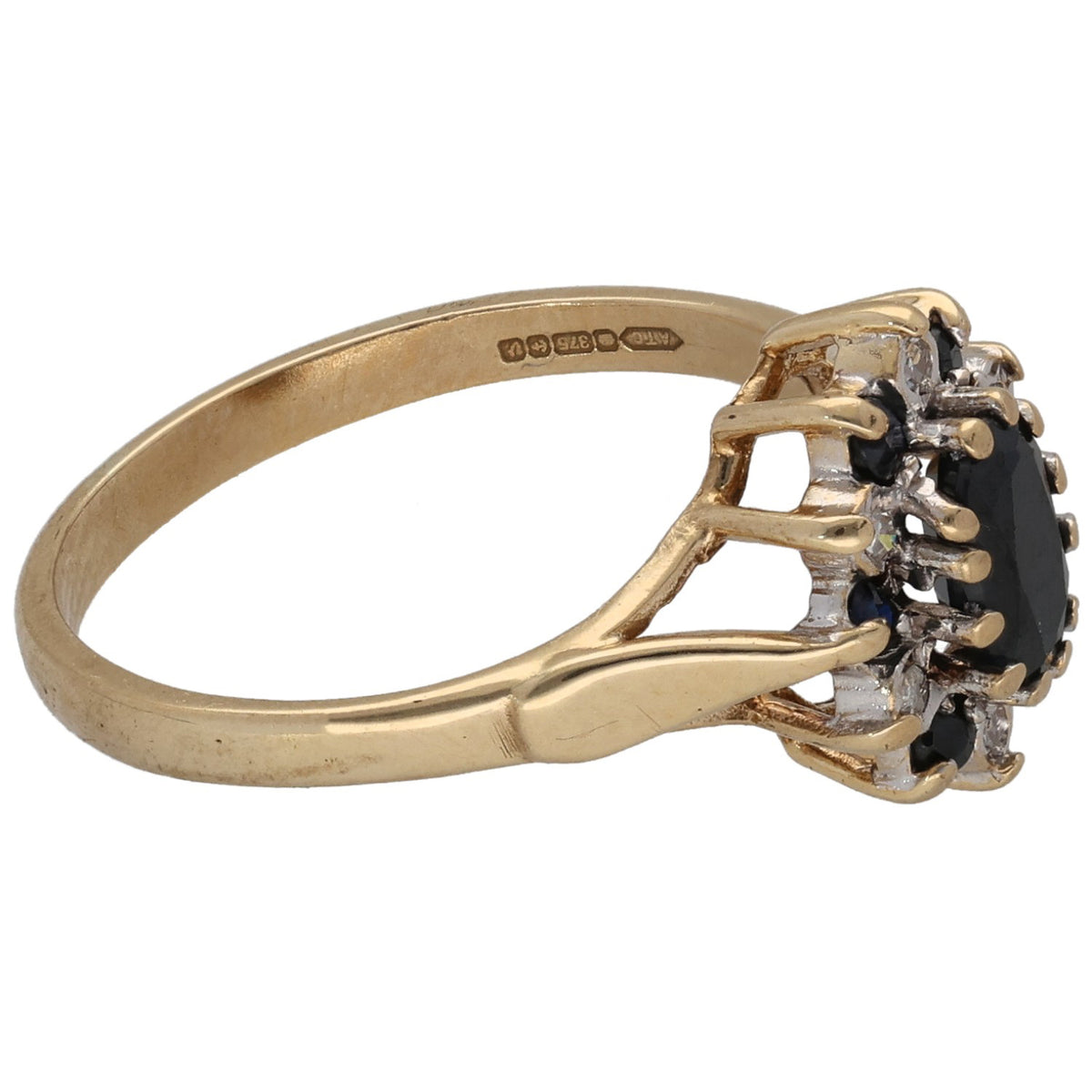 Gold cluster ring side view with raised dark center stone and round diamond halo