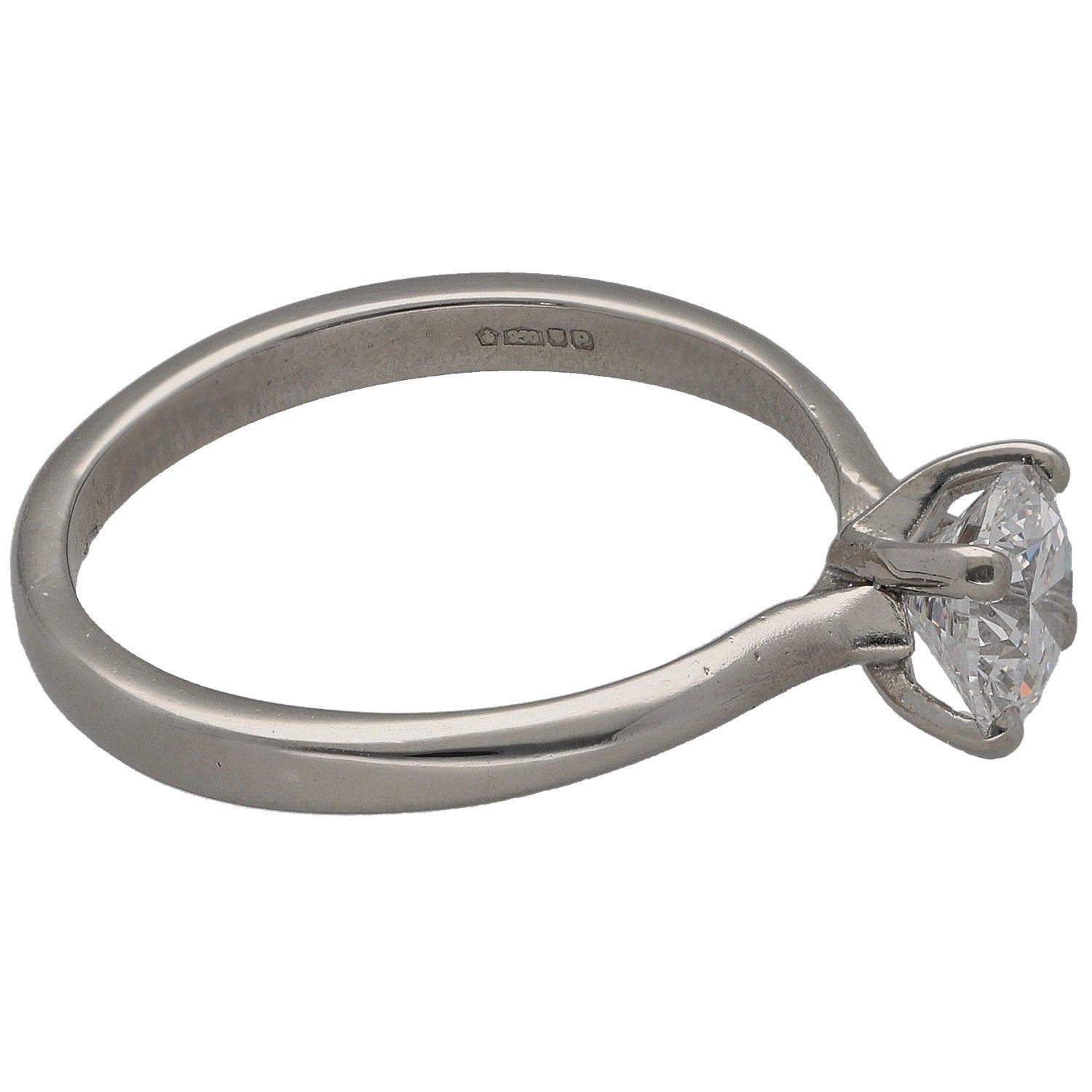 Platinum solitaire ring with side view of round diamond and metal prongs