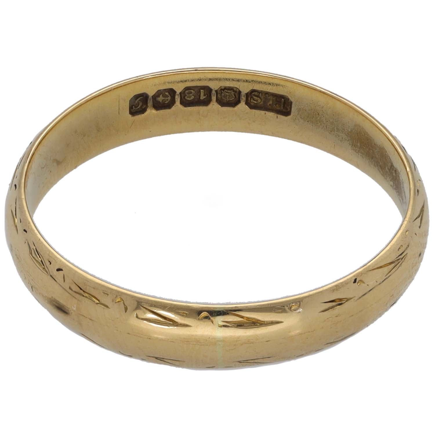 Gold wedding ring inside view showing engraved inscription across band