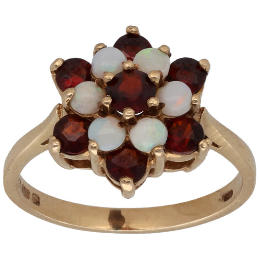 Gold cocktail ring with dark red garnet cluster and white opal accents, prong-set