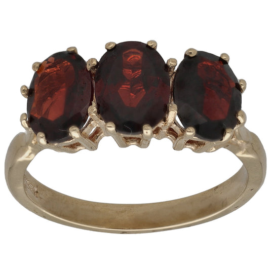 9ct gold three-stone ring with three oval dark red garnets in shared prongs