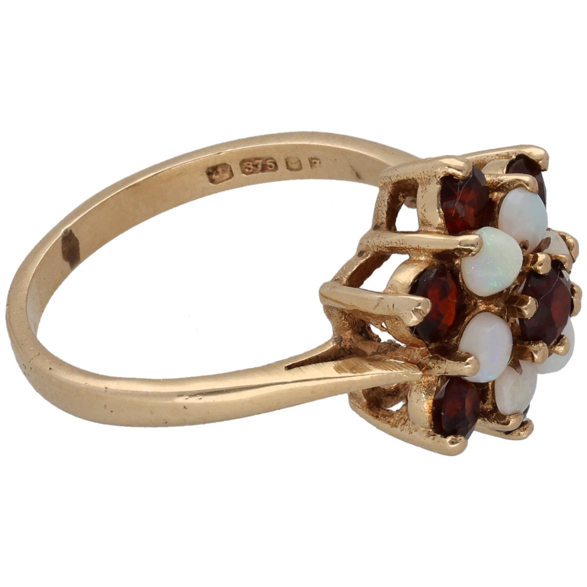 Gold ring side view with prong-set dark red garnets and white opal stones; hallmarked
