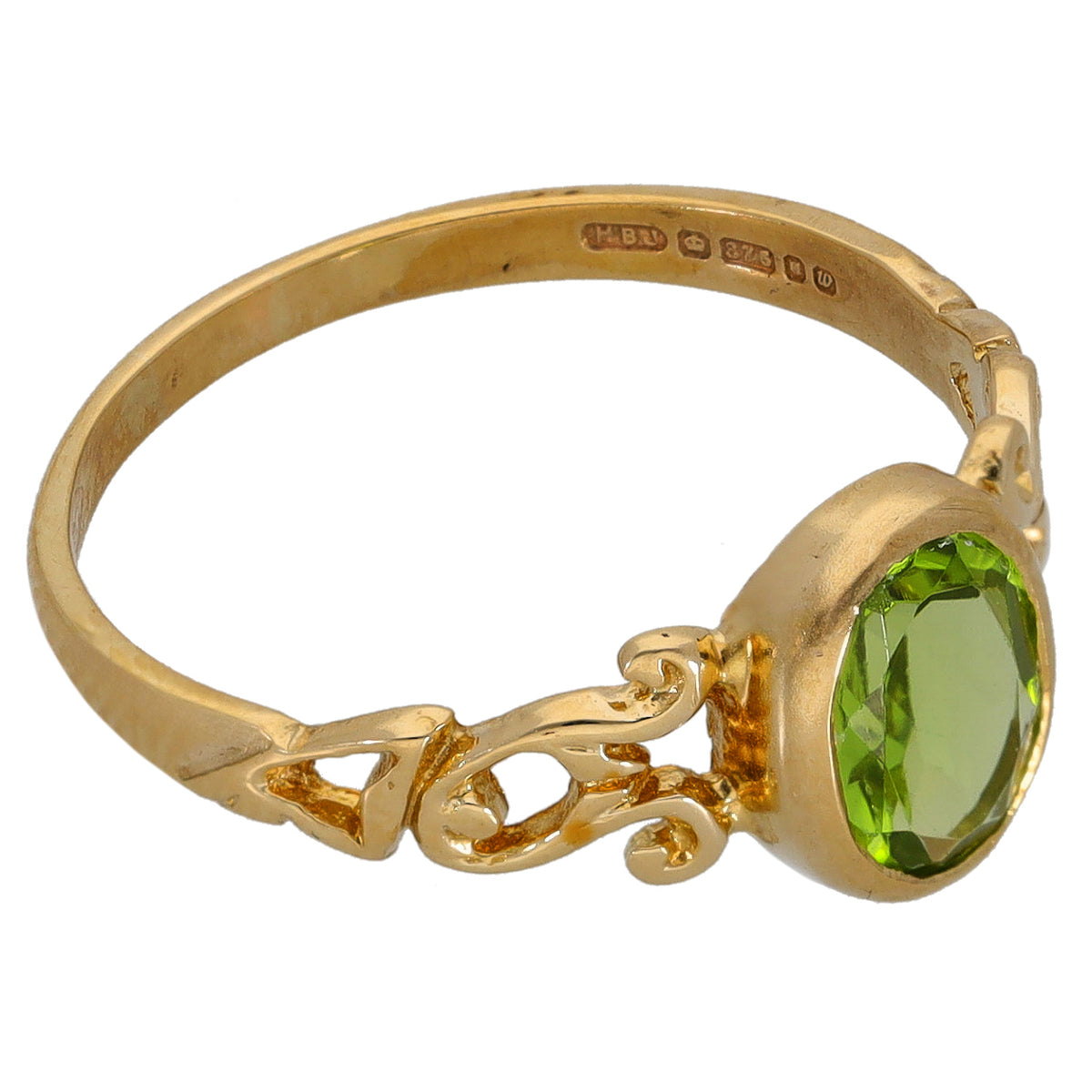 Gold peridot single-stone ring with oval green gemstone in ornate gold setting