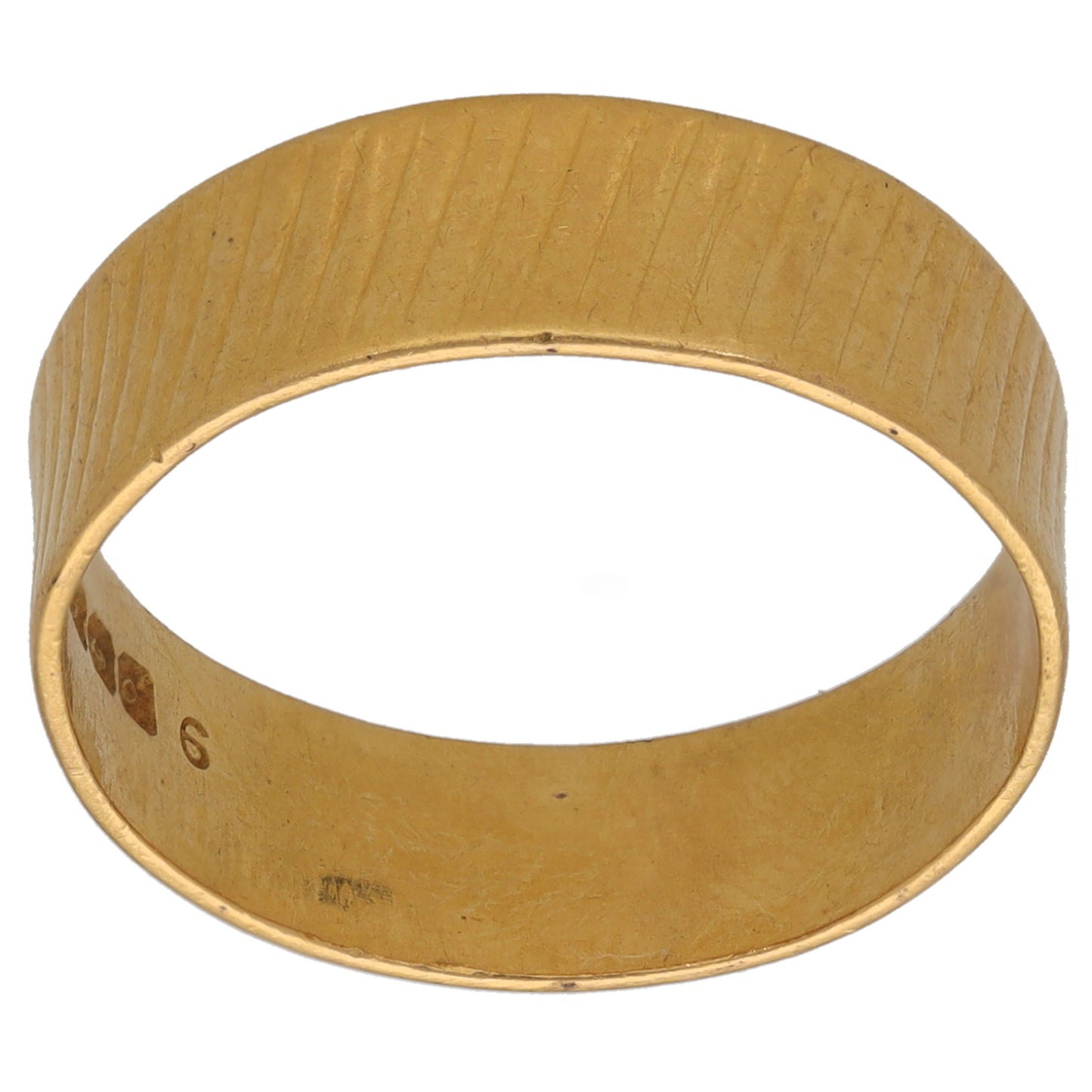 Gold wedding ring with textured patterned band and interior hallmark markings