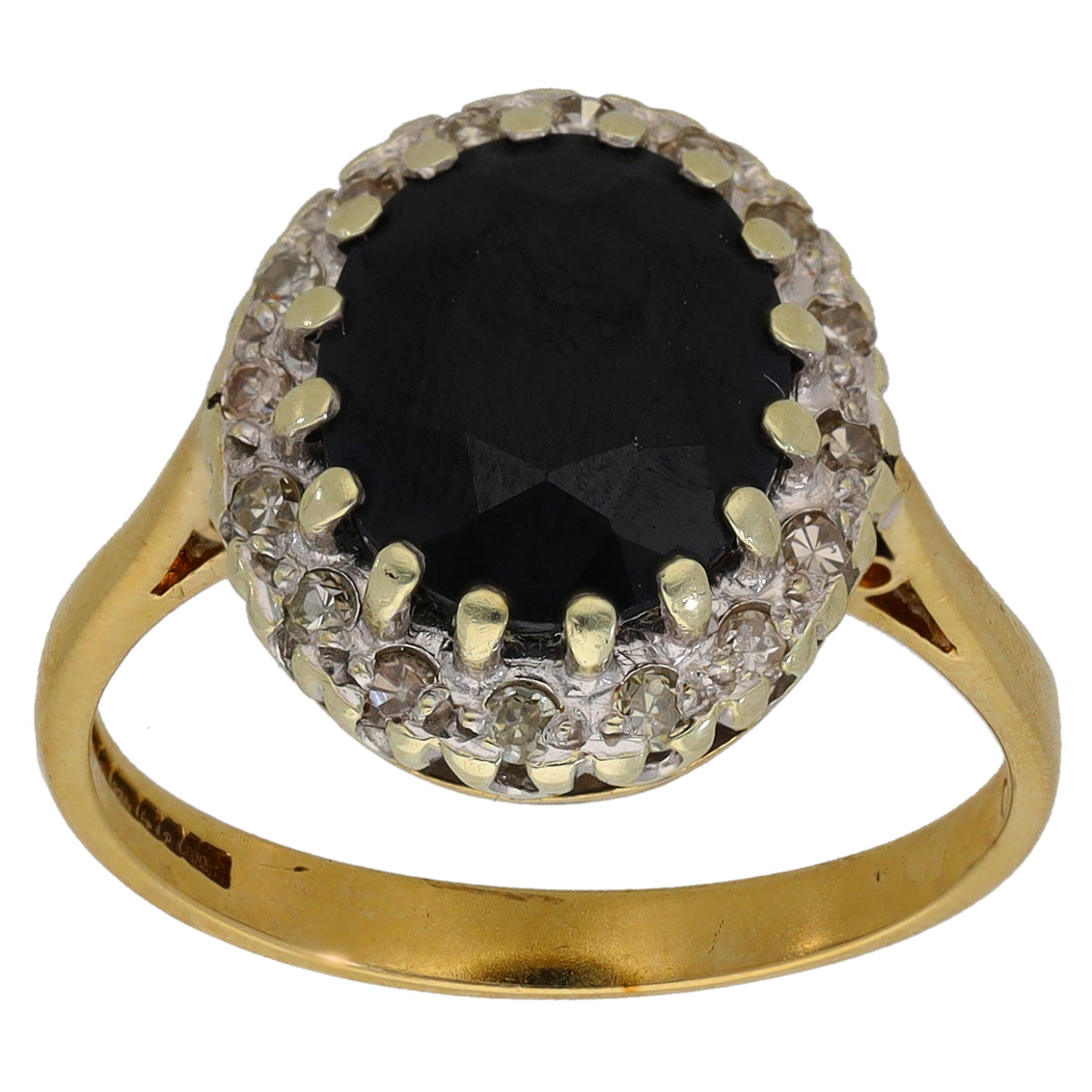 Gold dress ring featuring dark round center stone with diamond halo setting
