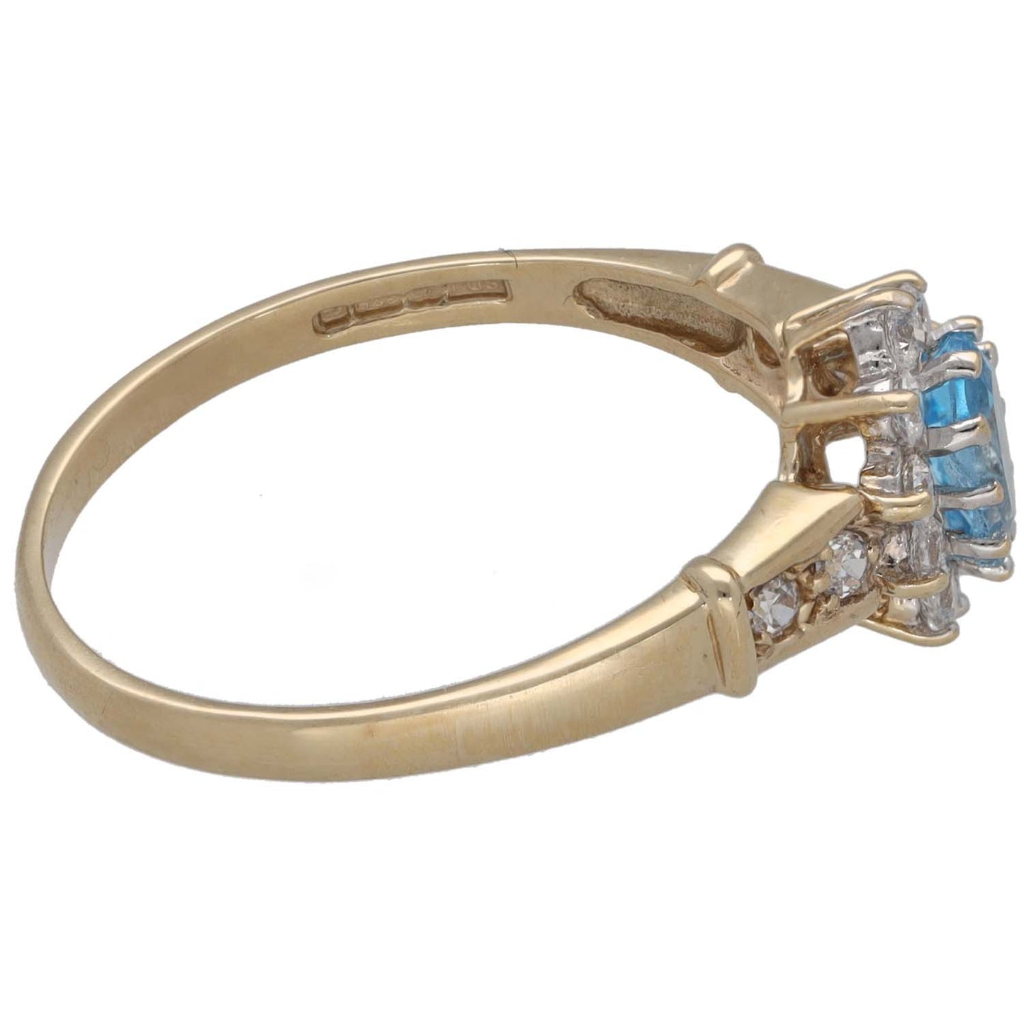 Gold ring band with side cluster of oval blue stone and clear CZ accents