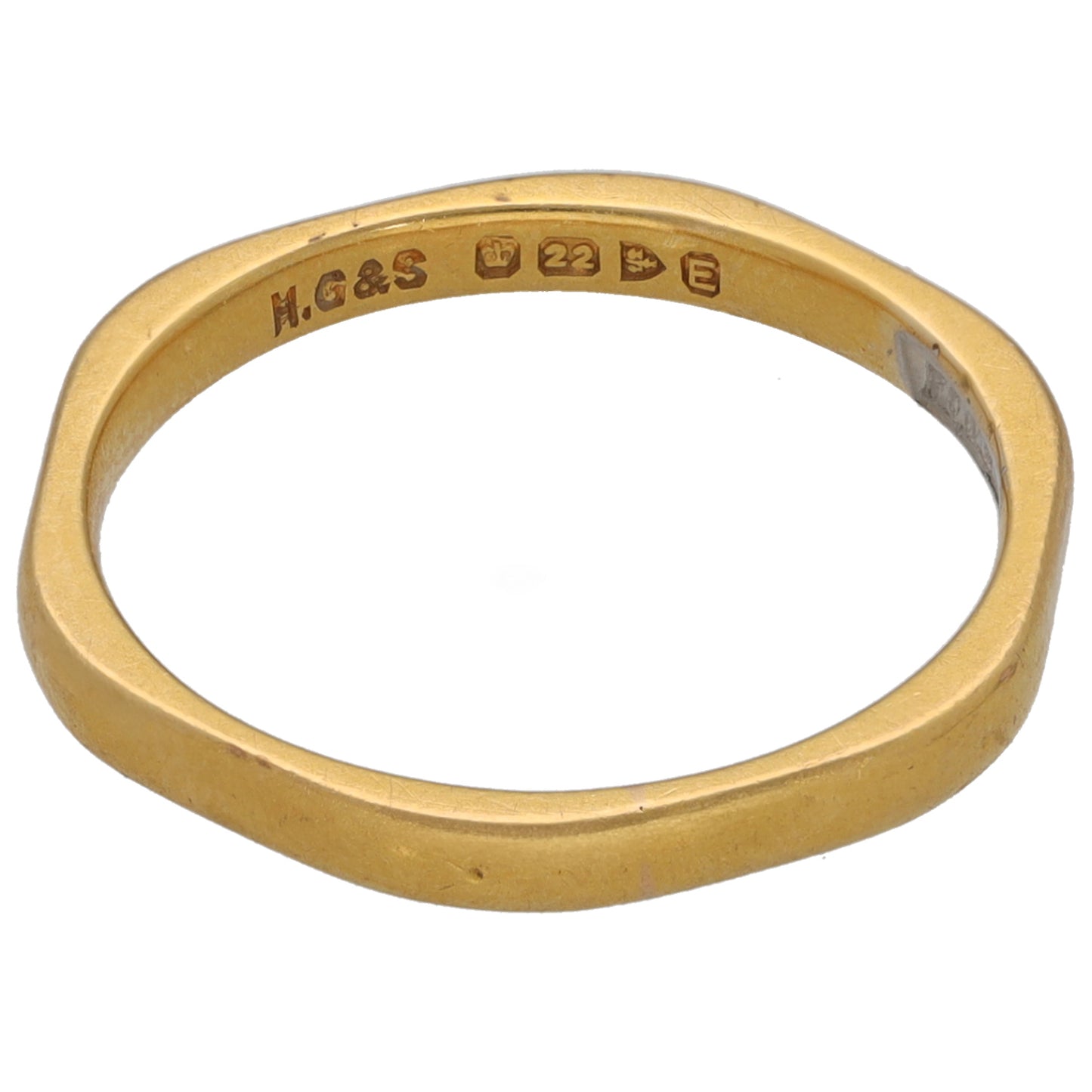 Gold wedding ring band with '22' stamp, inner edge view.