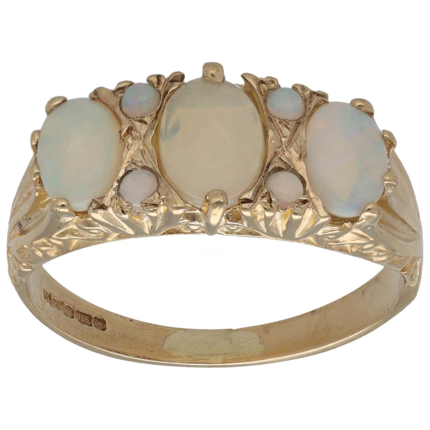 Opal cocktail ring in gold tone with oval pale blue stones, scalloped setting