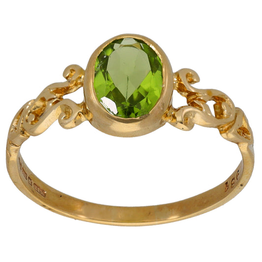 Gold single-stone ring with large oval green gemstone bezel setting