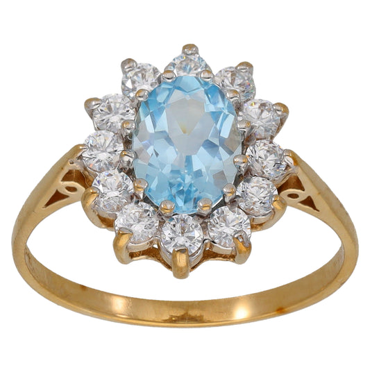 Gold ring with oval light-blue gemstone center and clear CZ cluster halo