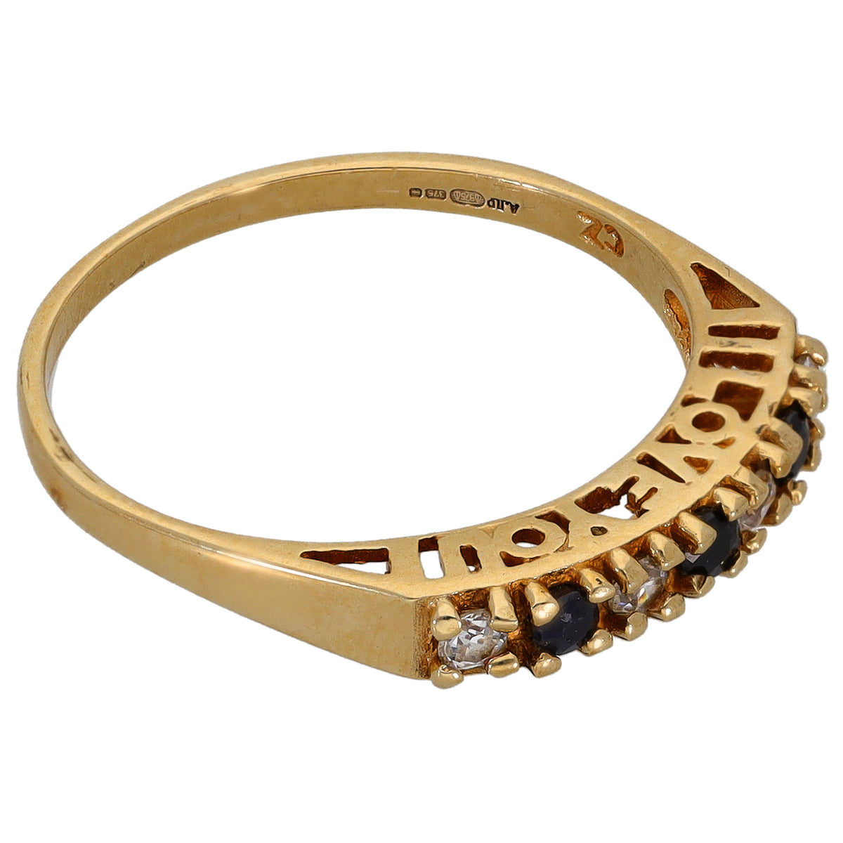 Gold half eternity ring side view with blue and clear stones set across band