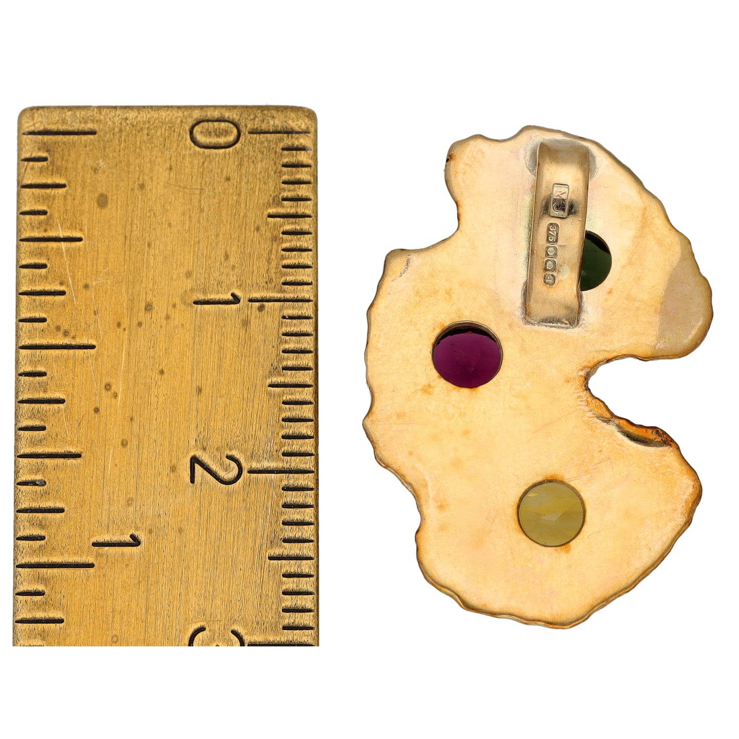 Gold pendant with dark purple and olive gemstones, prong and bail detail