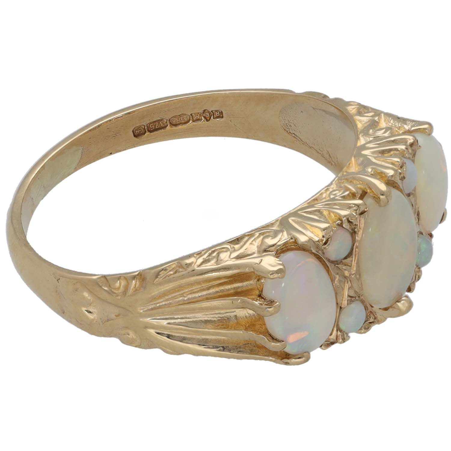 Gold tone opal cocktail ring with oval stones on side, engraved inner band