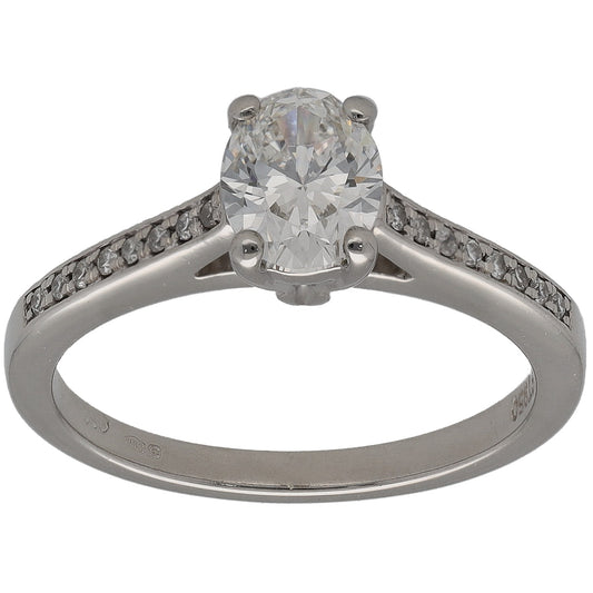 Platinum diamond solitaire ring with round center stone and pave accent on the band