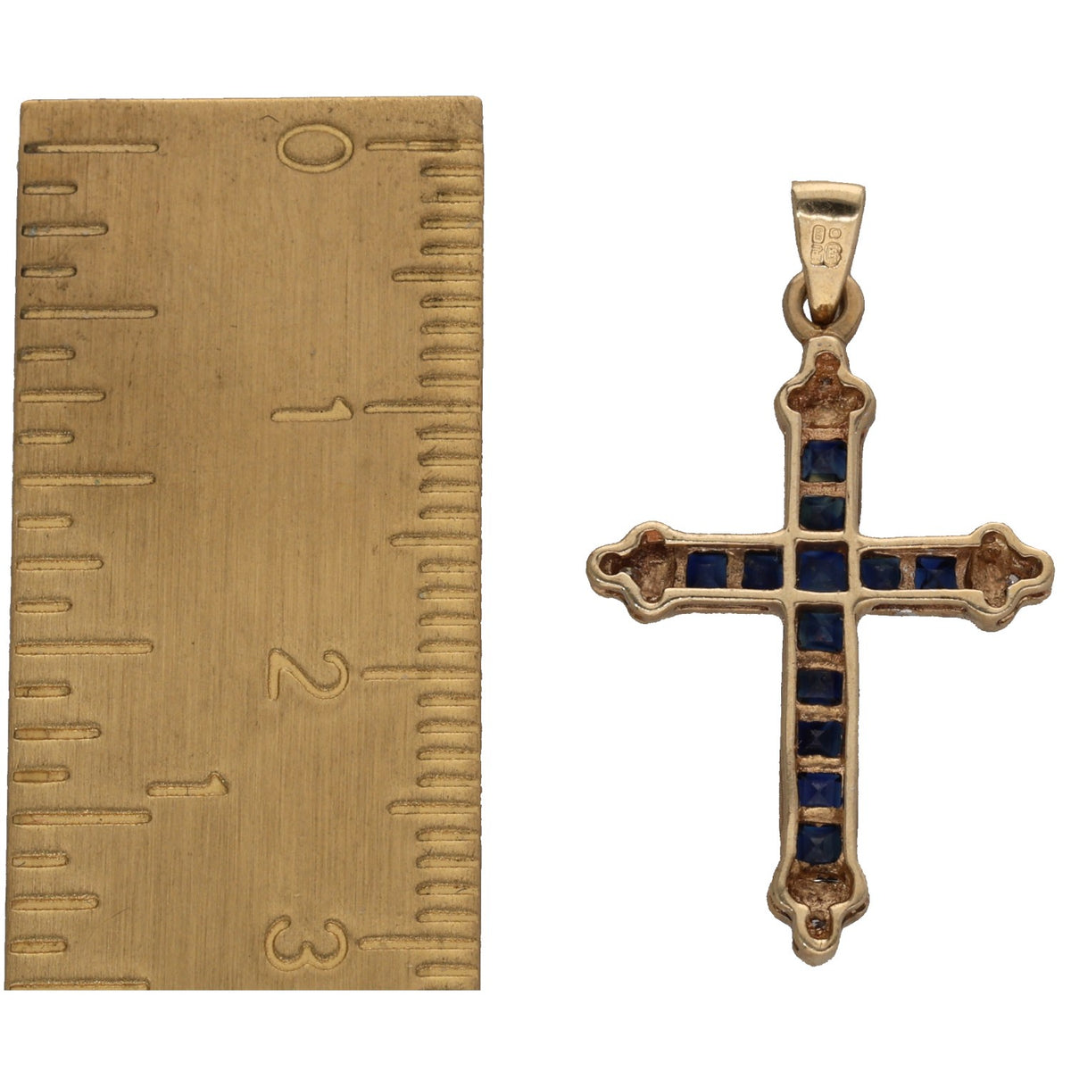 Gold cross pendant with blue sapphire insets and small round diamond accents
