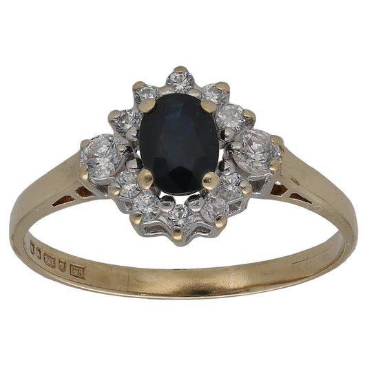 Gold oval sapphire and CZ halo ring, oval dark center stone with clustered accents