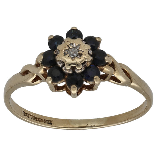 9ct gold sapphire cluster ring with dark stones and center round diamond flower