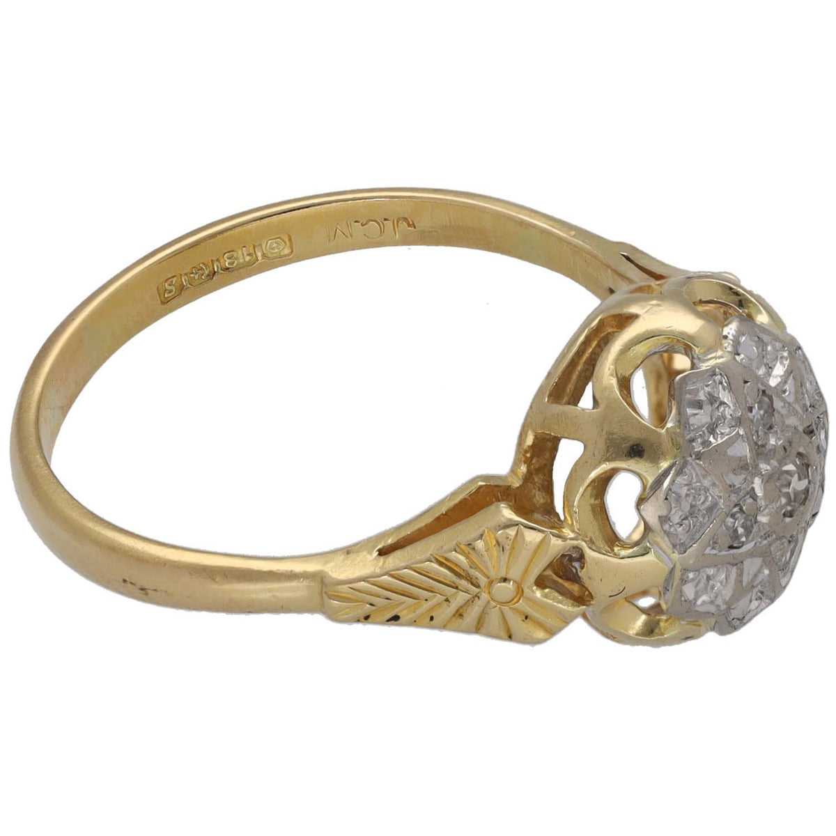 Gold ring with a round diamond cluster and decorative side cutouts on the shank