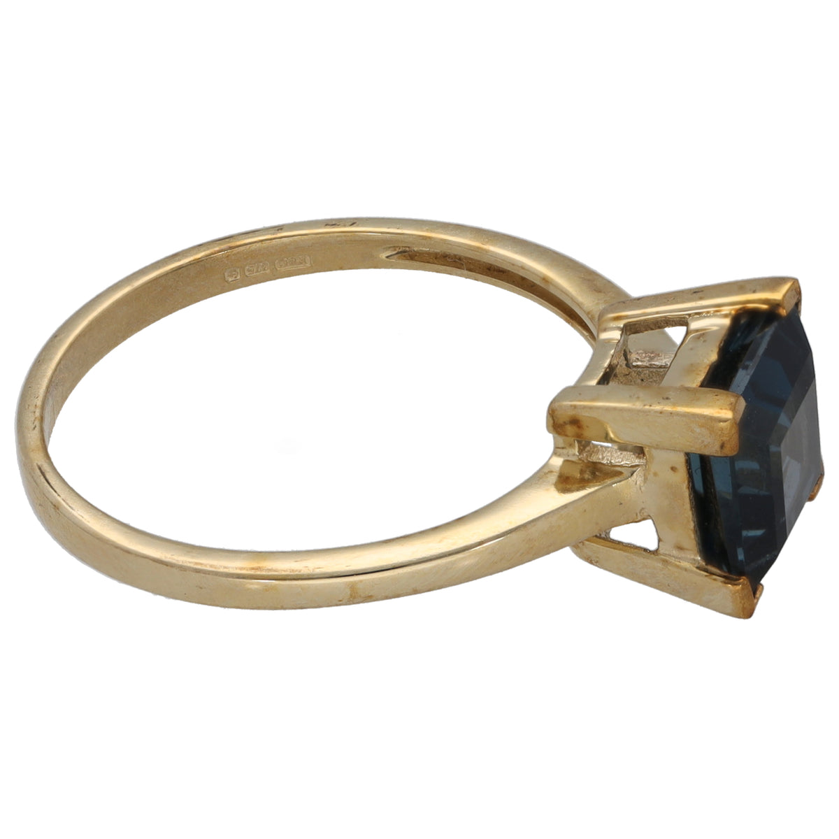 Gold single-stone ring with dark blue gemstone and open side prongs