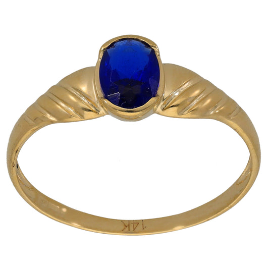 Gold-tone ring with raised blue oval gemstone on slim band with engraved pattern