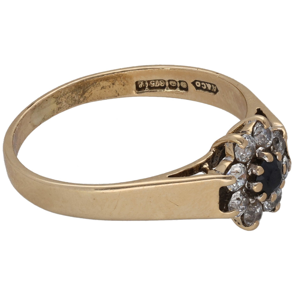 9ct gold ring with engraved band and side CZ cluster around a dark center stone
