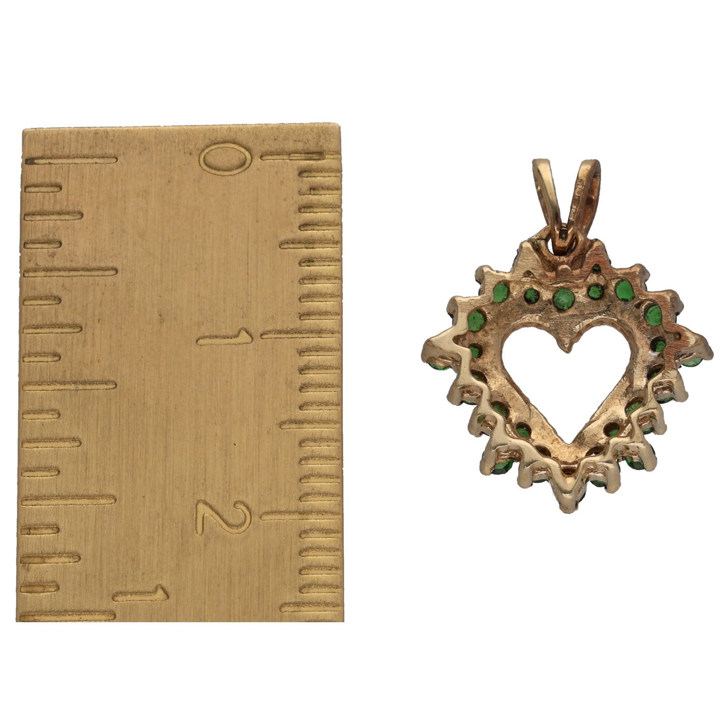 Gold-tone heart pendant shown with ruler for size; green gemstone cluster bail