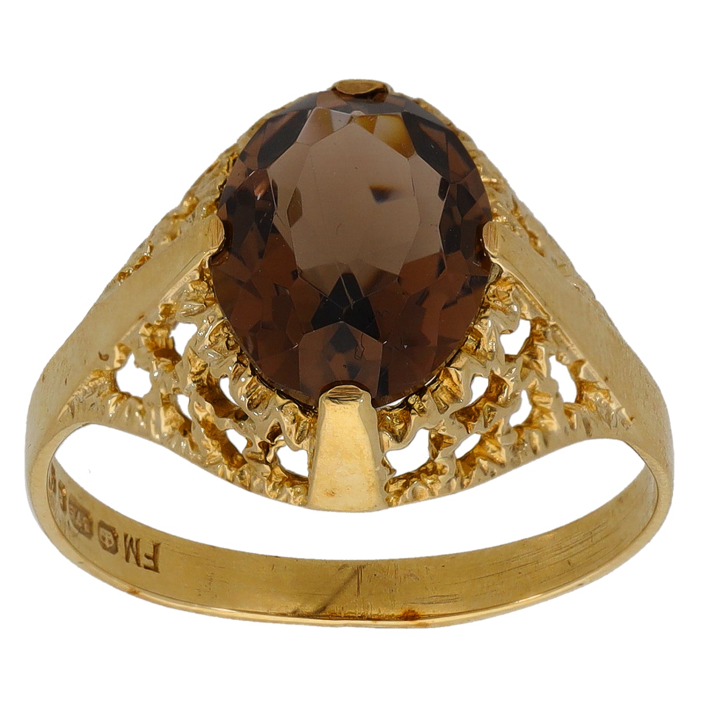 Gold ring with large faceted dark gemstone and ornate openwork shoulders