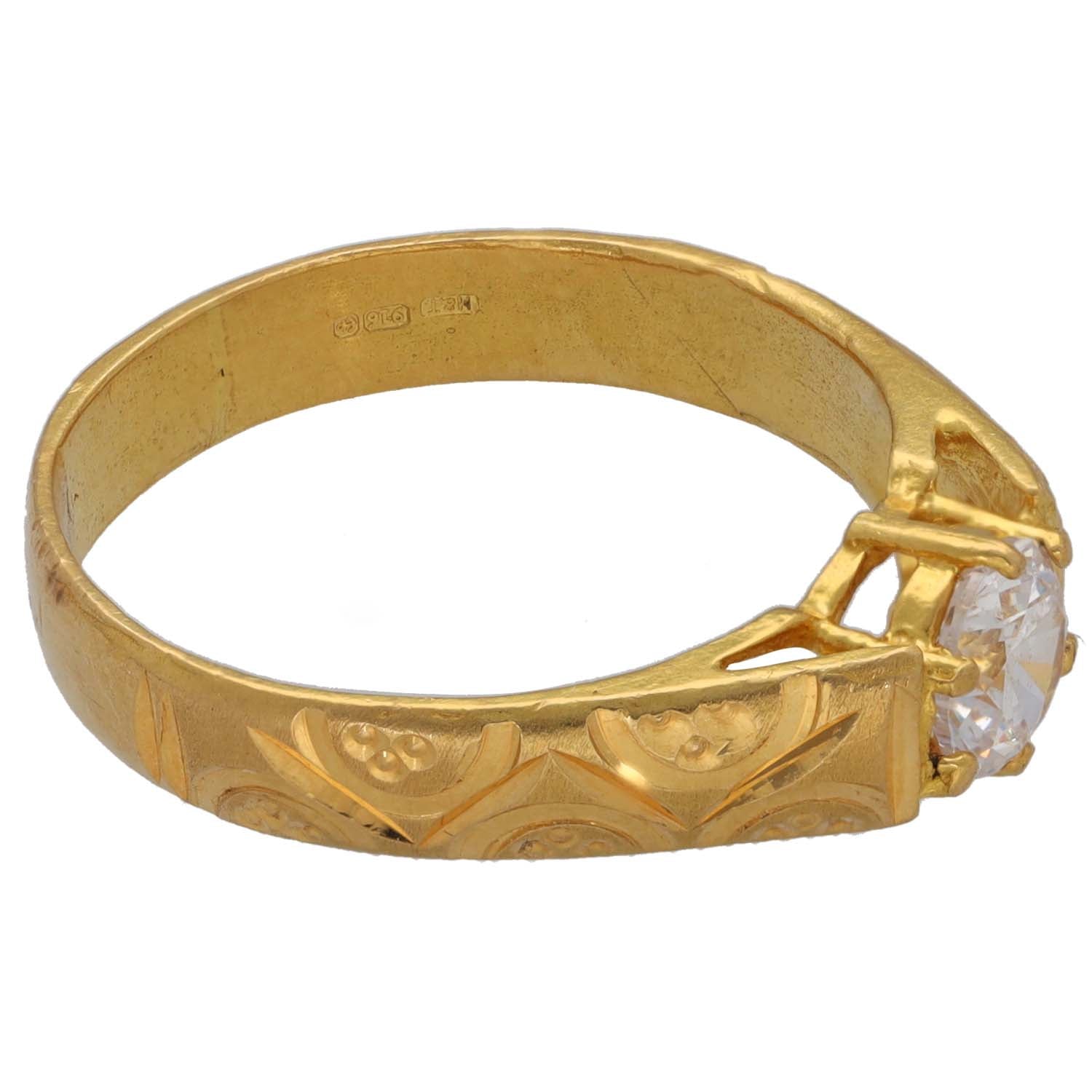 Gold CZ ring with engraved band and side prongs holding round clear stone