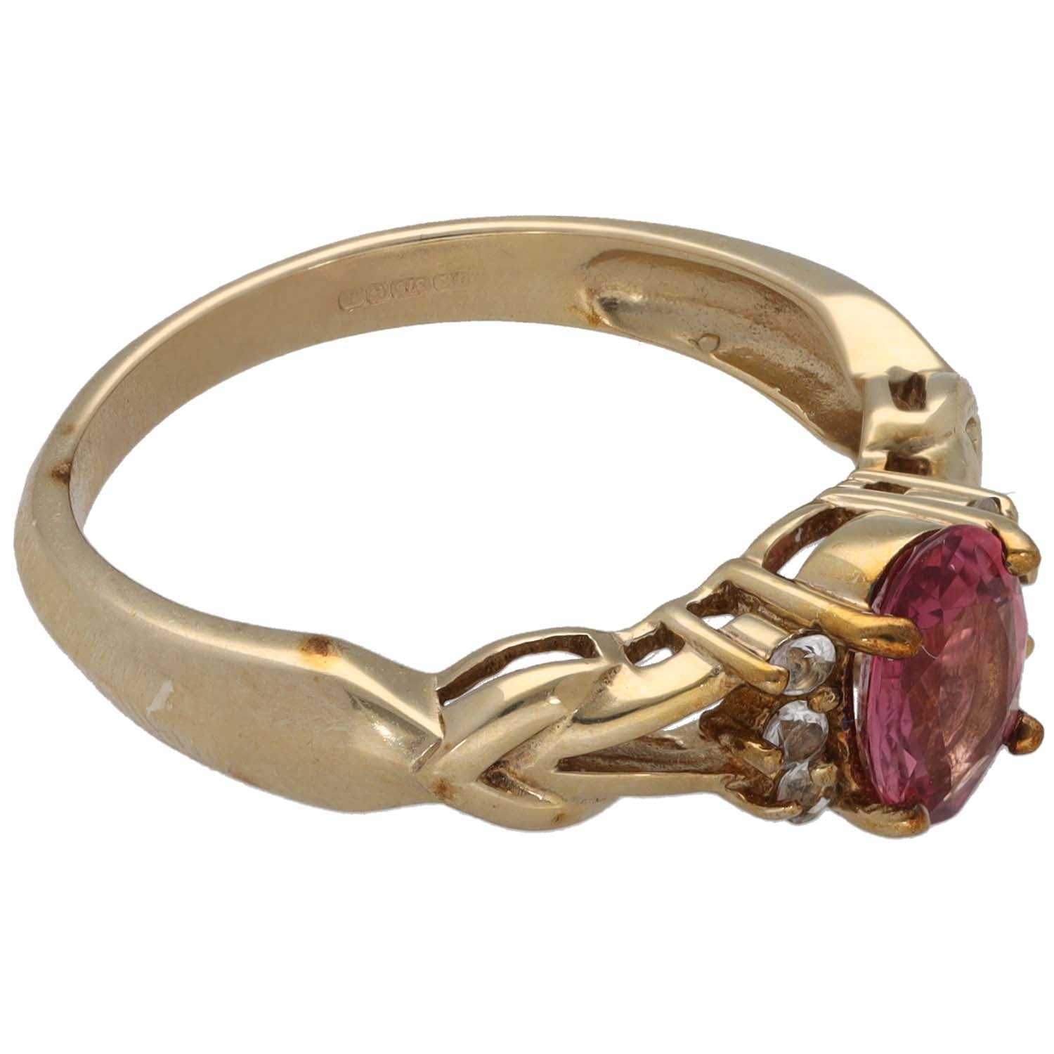 Gold dress ring with side-set oval pink gemstone, small clear stones, size M