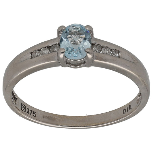 Gold-toned ring with blue gemstone center and small diamond accents around