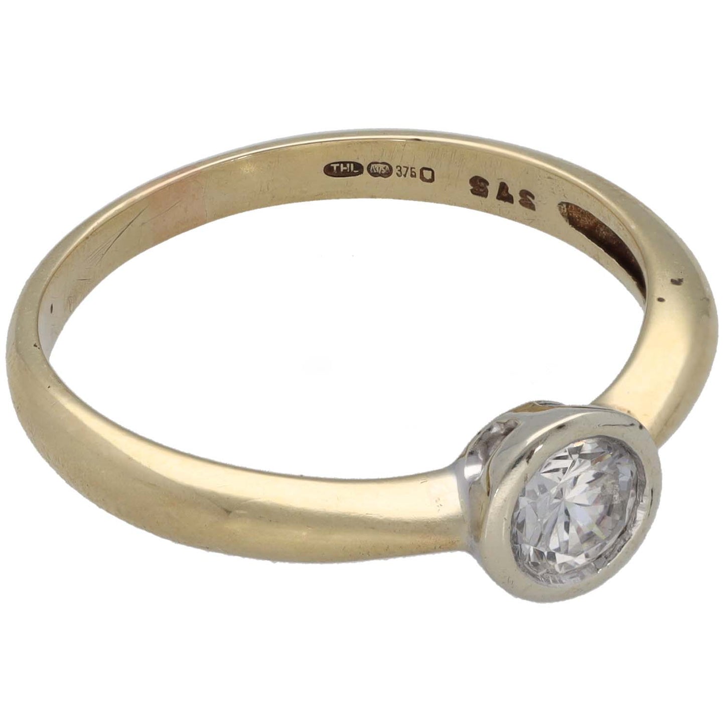 Gold-tone ring with round CZ solitaire and silver-toned bezel setting, side view
