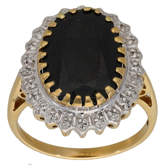 Gold cocktail ring with dark oval center stone, scalloped diamond halo and beaded edge