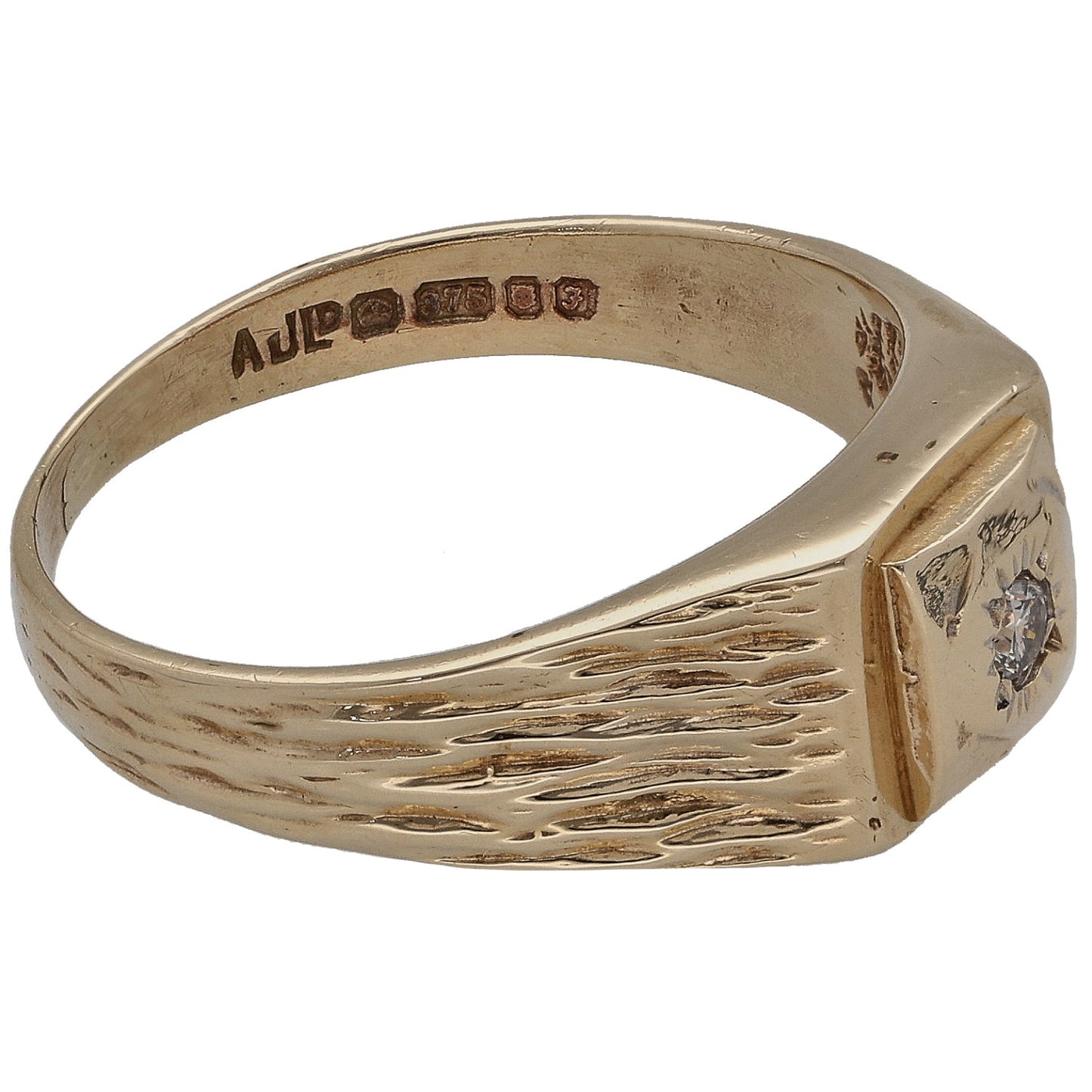Gold signet ring with engraved wave pattern and round diamond detail, inside stamped