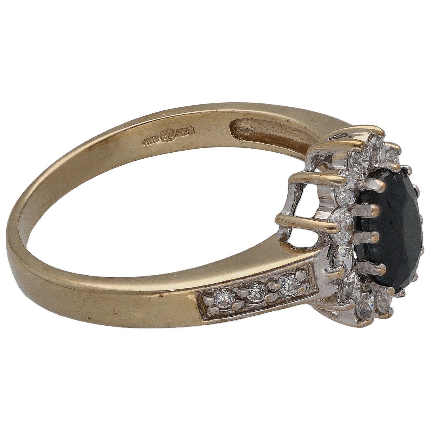 Gold ring profile with oval dark stone in prong setting and clear stone details