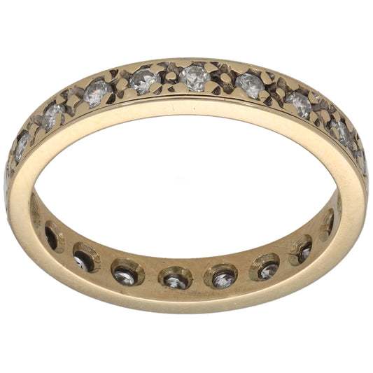 Gold eternity ring with round diamond accents, channel-set across the top and sides