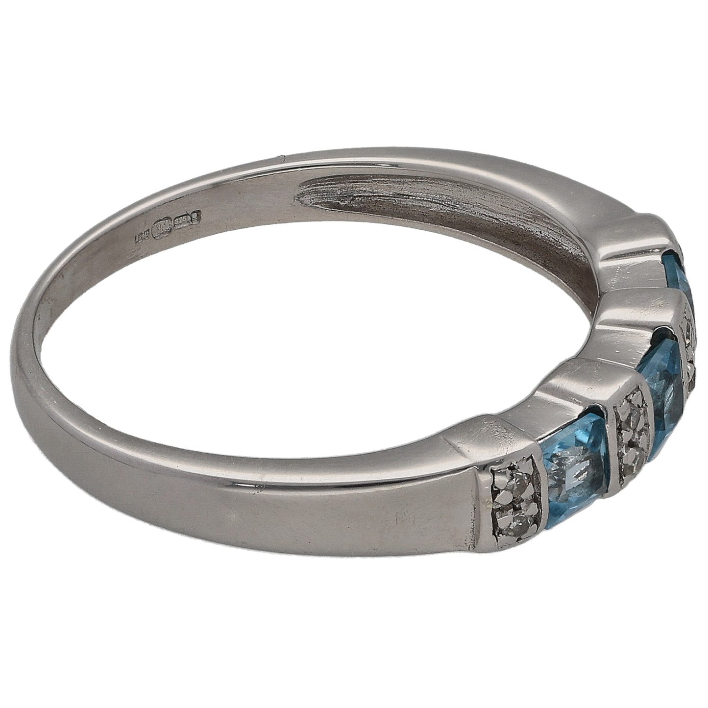 Half eternity ring side view with blue topaz and round diamond clusters in white metal