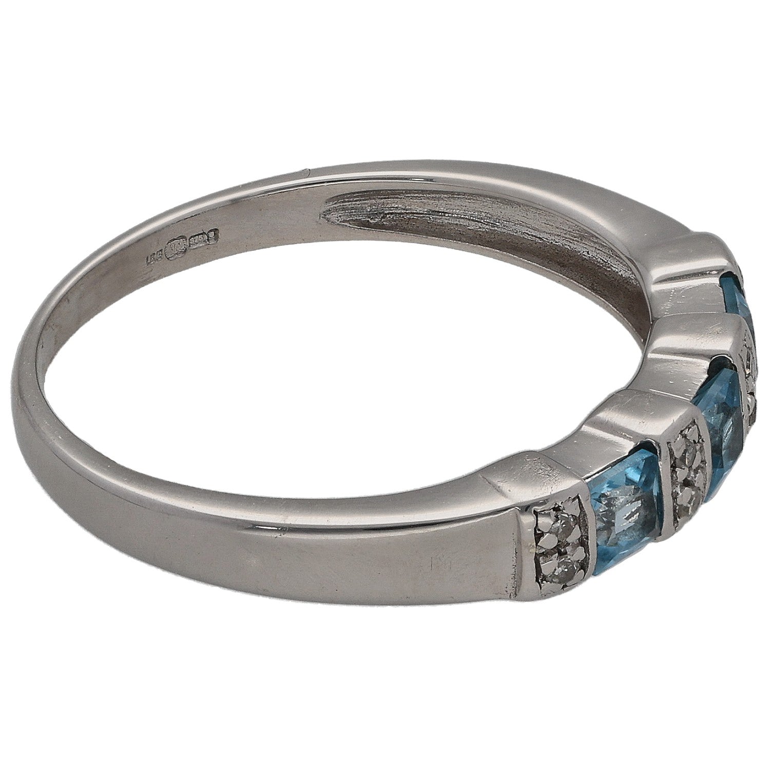 Half eternity ring side view with blue topaz and round diamond clusters in white metal