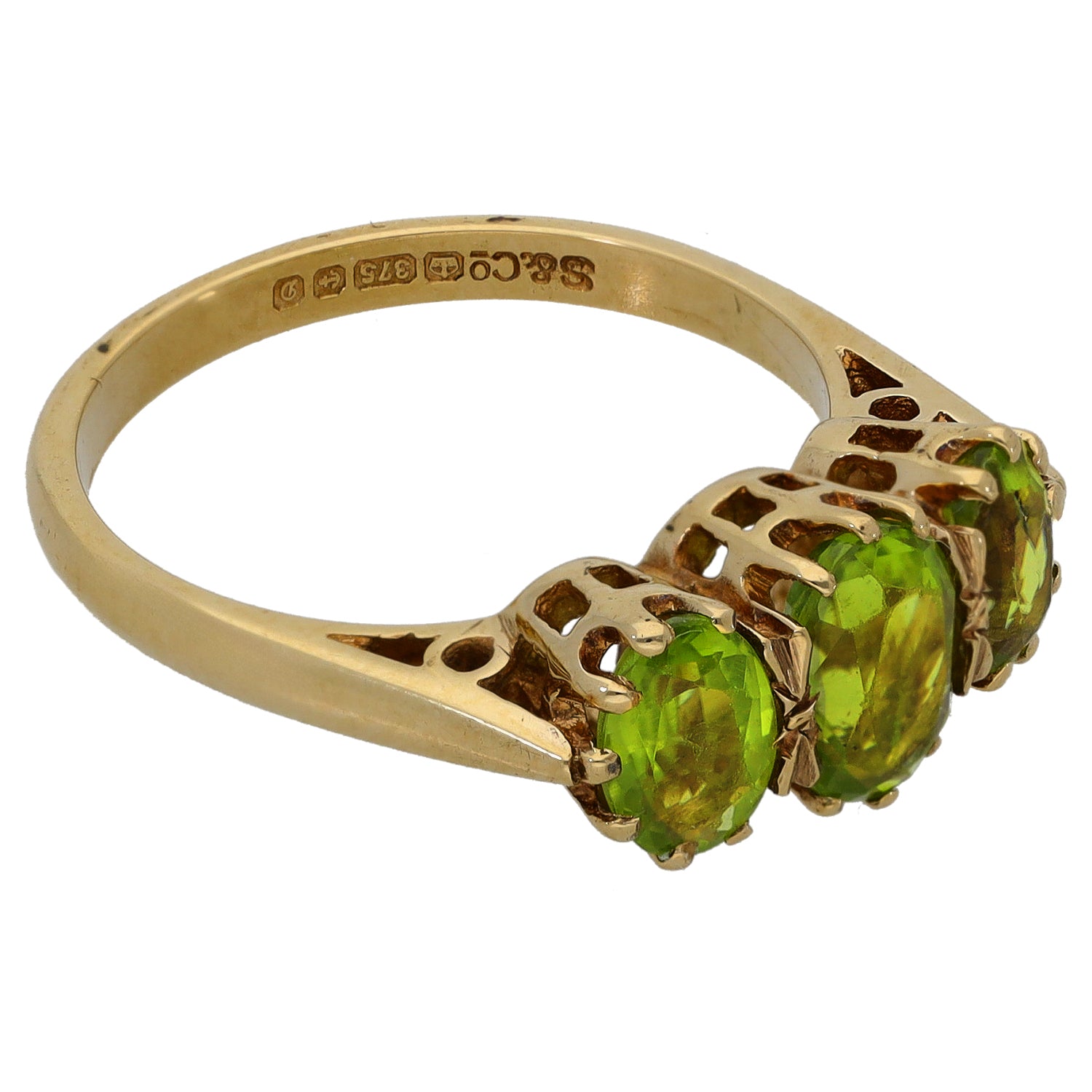 9ct gold three-stone ring with three oval green peridots in openwork setting