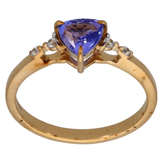 Gold ring with pear-cut blue center stone and small round diamond-look accents