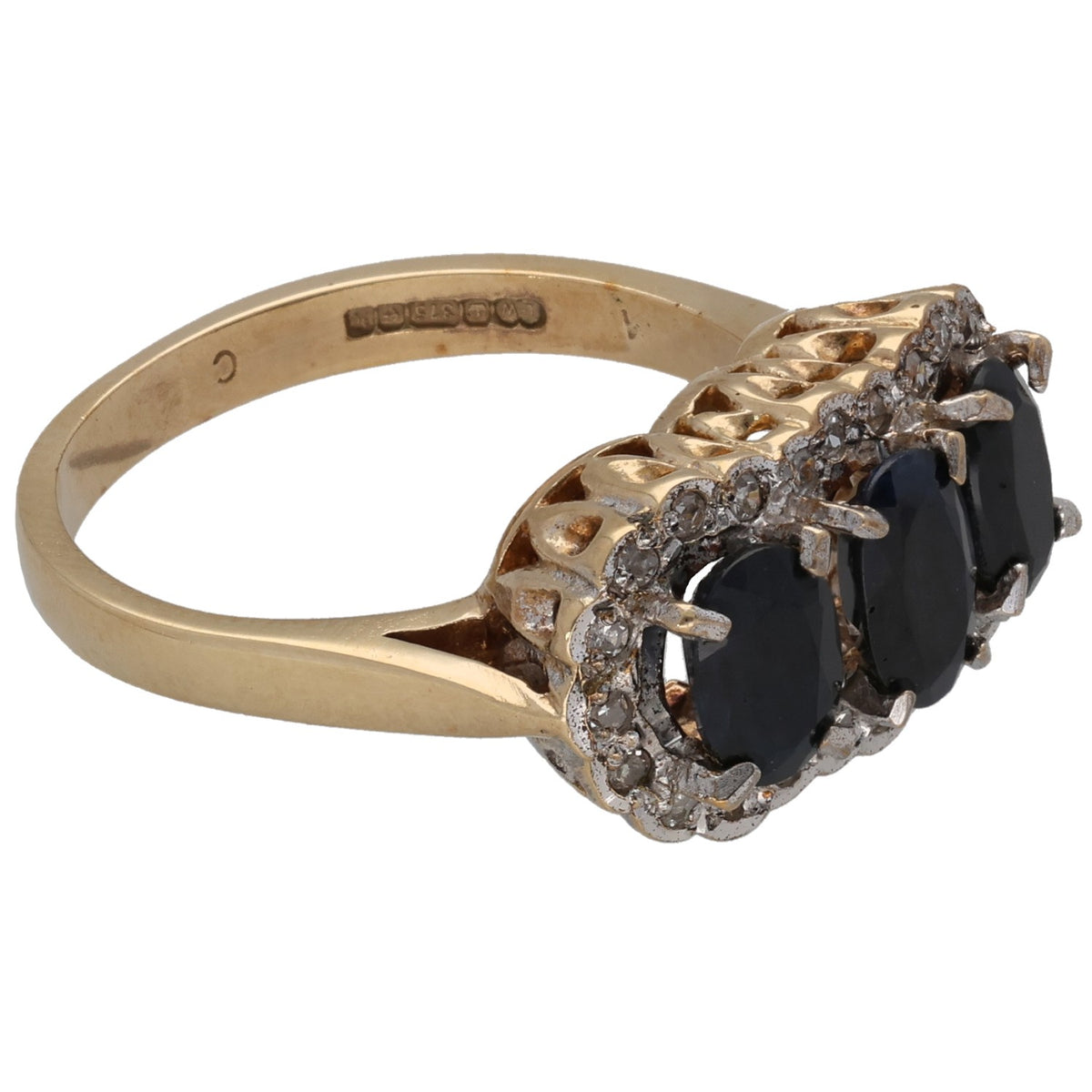 Gold ring side view with three dark oval stones in claw settings and diamond accents